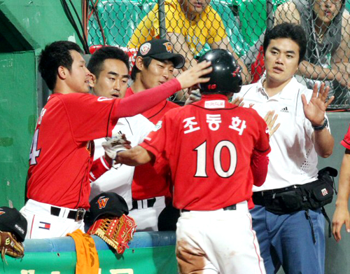 30일 광주 무등경기장에서 열린 2010 프로야구 기아 타이거즈와 SK 와이번즈의 경기에서 11회초 2사 만루 SK 8번 조동화가 3타점 3루타를 때려내고 동료들과 기뻐하고 있다. SK 9-5 리드.