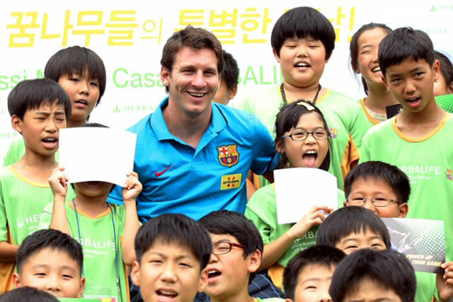 FC 바르셀로나 리오넬 메시가 3일 오후 서울 강서구 메이필드호텔에서 축구 꿈나무들과 만났다. FC 바르셀로나의 공식 뉴트리션 스폰서인 허벌라이프 주최로 열린 이 행사에서 아이들은 메시와 축구에 대한 궁금증을 풀고 함께 축구공을 차는 등 특별한 시간을 가졌다. 사진은 아이들과 메시가 함께 기념촬영하는 모습.