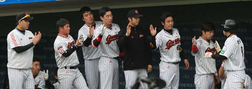 23일 부산 사직야구장에서 열린 2011 프로야구 플레이오프 5차전 롯데 자이언츠와 SK 와이번스의 경기. 6회말 무사 1,2루에서 롯데 강민호의 적시타 때 홈인한 전준우가 동료들의 축하를 받고 있다.