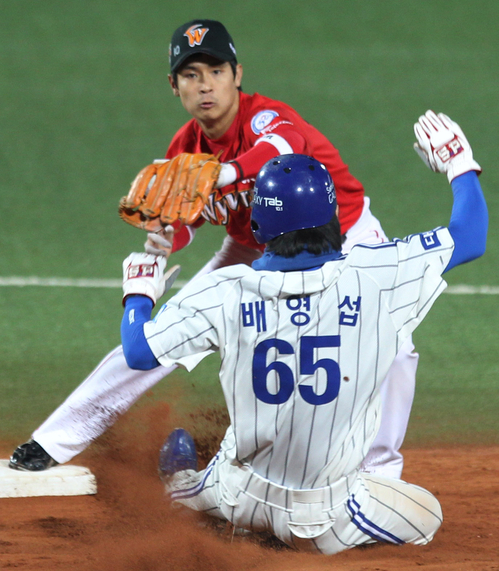 삼성과 SK의 프로야구 한국시리즈 2차전 5회말 1사 1루. 삼성 김상수 내야 땅볼 때 배영섭이 2루에서 아웃되고 있다. SK 수비는 최윤석 유격수.   26일 대구시민운동장.