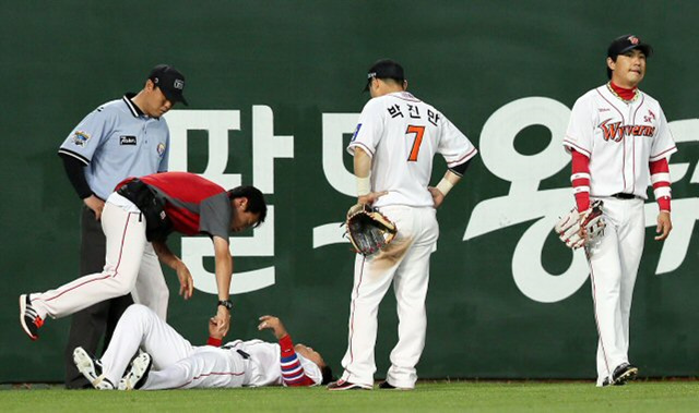 19일 오후 인천 문학구장에서 열린 삼성 라이온스 대 SK 와이번스의 경기. 7회초 삼성 공격 1사 상황에서 조동찬이 좌익수 뒤로 친 2루타를 SK 김상현이 잡으려다 펜스에 추돌, 바닥에 쓰러져 고통스러워 하고 있다.