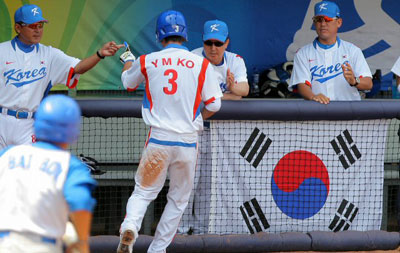 19일 베이징 우커송야구장에서 열린 올림픽 남자야구 예선 한국-쿠바 전 6회말 2사 3루, 이용규의 안타를 틈타 홈인한 고영민이 감독과 코치진으로 부터 축하를 받고 있다. 