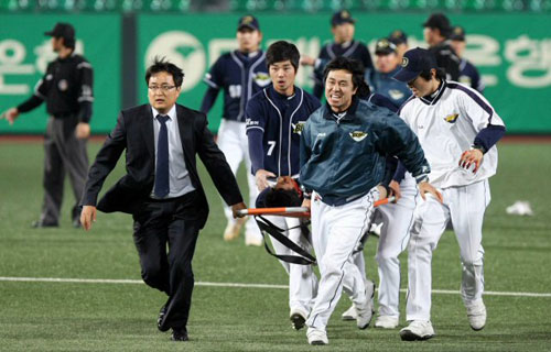2일 광주 무등경기장에서 벌어진 '2009 프로야구' KIA 타이거즈와 두산 베어스의 경기에서 8회말 무사 KIA 2번타자 김종국의 외야 플라이를 두산 외야수 이종욱이 잡으려다 오른쪽 턱에 깊은 부상을 입고 들것에 실려 후송되고 있다. 