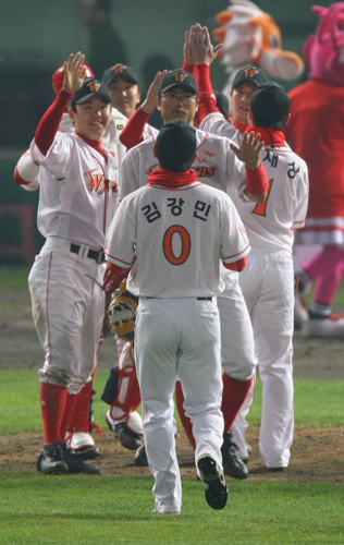 14일 오후 인천 문학야구장에서 열린 프로야구 플레이오프 5차전에서 두산베어스에 14대3으로 대승, 한국시리즈 진출을 확정지은 뒤 투수 정우람과 SK 선수들이 자축하고 있다. 
 